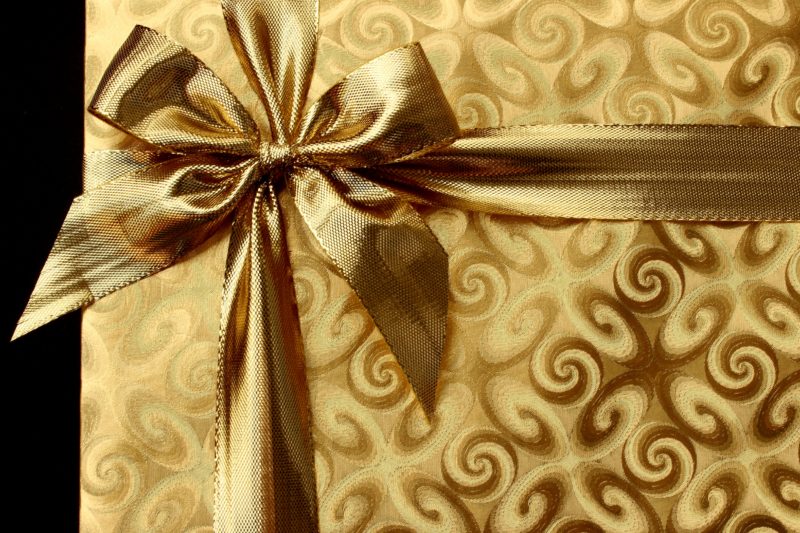 gift wrapped in gold paper with gold bow