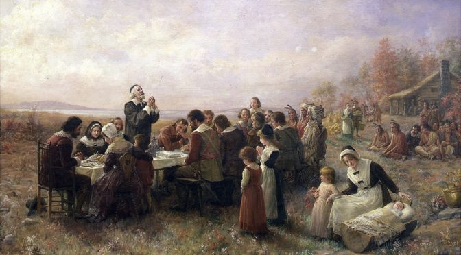 Painting of pilgrims and native Americans celebrating the first Thanksgiving feast
