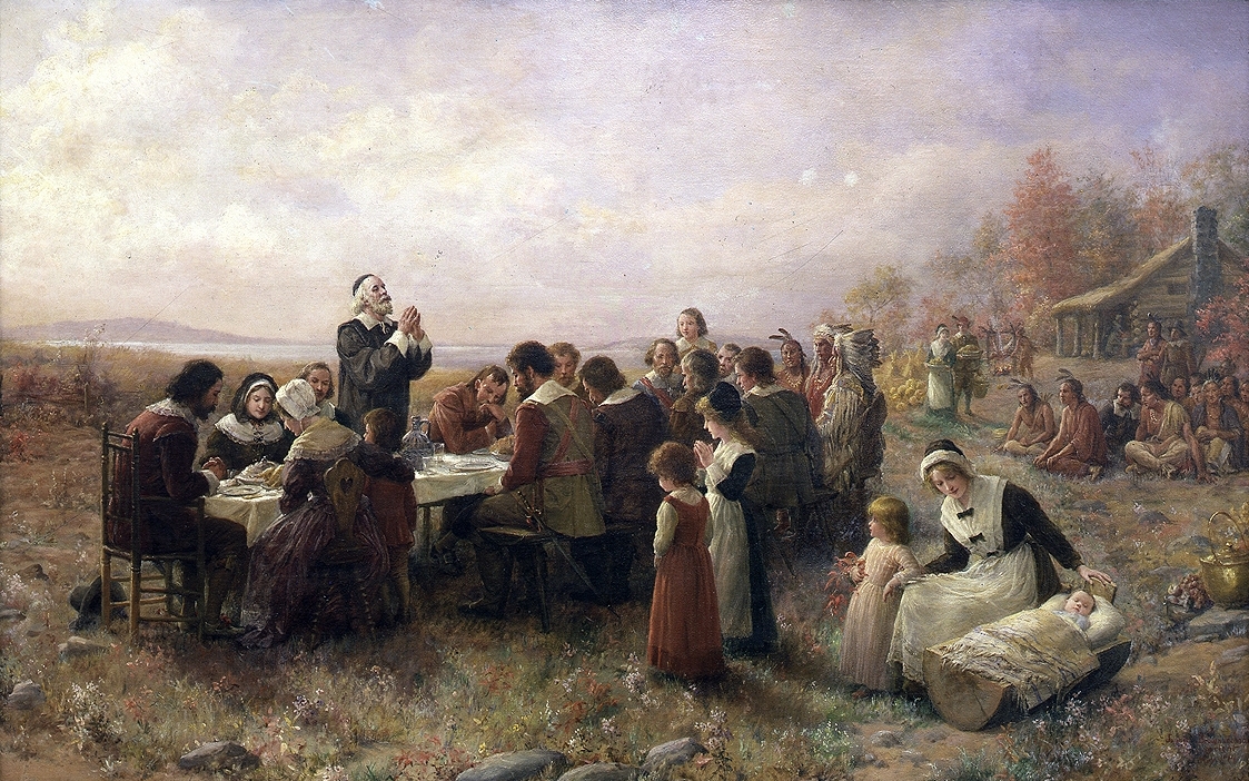 Painting of pilgrims and native Americans celebrating the first Thanksgiving feast